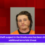 A package theft suspect in the Omaha area has been charged with additional terroristic threat